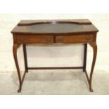 An Edwardian inlaid mahogany side table, the top with oval writing surface, (superstructure lacking)