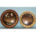 A gilt-framed circular convex mirror, the moulded frame applied with balls and with reeded