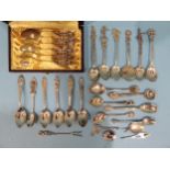 A cased set of six teaspoons with rose finials, marked 835 and other silver and white metal