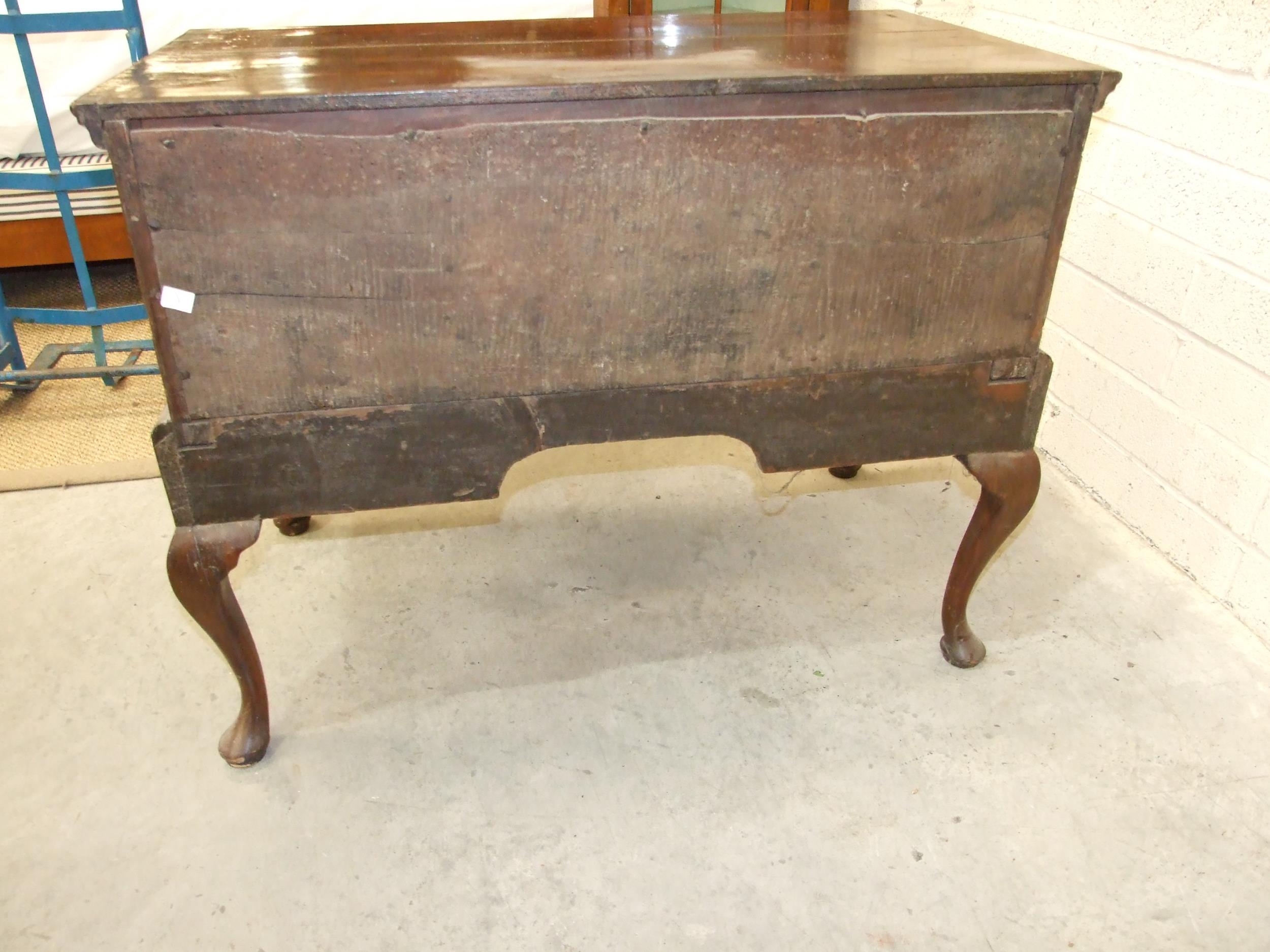 An 18th century walnut feather-banded lowboy, having a central drawer and two small cupboards, on - Image 4 of 4