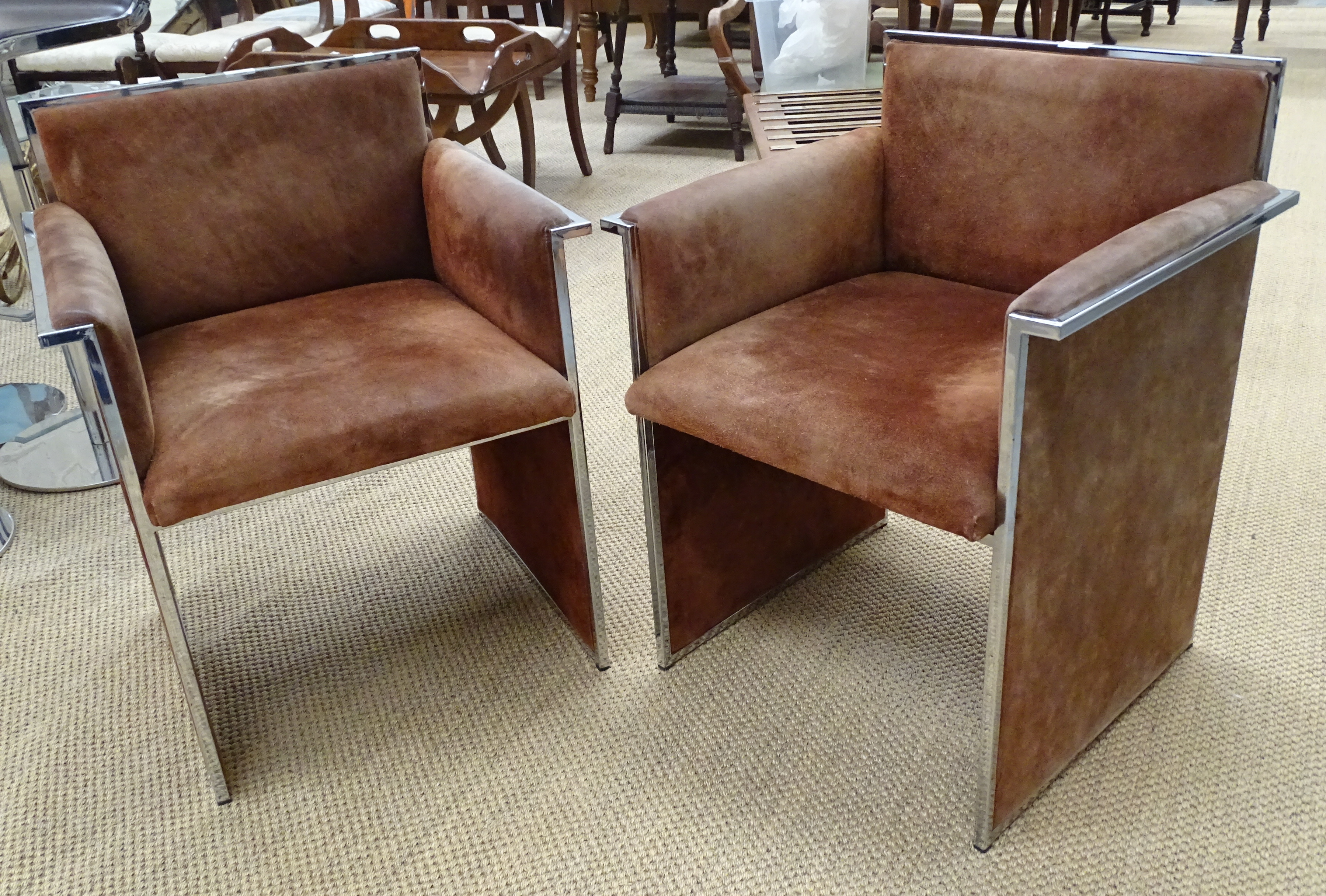 A pair of brown suede-upholstered chrome armchairs, (some fading and discolouration), (2).