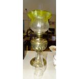 A brass oil lamp with embossed Art Nouveau decoration, with yellow and clear glass etched