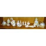 A pair of Dresden figure ornaments, four lace figurines, three porcelain pin cushion ladies and