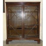 A mahogany bookcase fitted with a pair of astragal-glazed doors, 95cm wide, 118cm high.