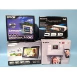A Samsung digital photograph frame, Epson Photo PC P-100 Viewer, Cahon Selphy CP1200 Printer and