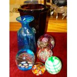 A Mdina glass vase, 19cm high, a purple glass vase and five modern glass paperweights, (7).