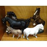 A collection of five Beswick horse sculptures: 'Black Beauty', 'Shetland Pony' (dapple grey), '