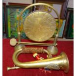 A brass bugle with applied Argyll and Sutherland crest, a brass gong with beater and a metal fire