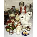 A collection of Torquay Pottery mottoware, including jugs, vases, etc, a pair of Staffordshire