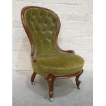 A Victorian walnut-framed spoon-back low salon chair with buttoned back, on cabriole front legs with
