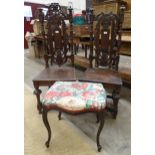 Two antique oak hall chairs with pierced carved back and solid seats and an upholstered serpentine
