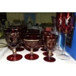 A collection of ruby and gilt-decorated drinking glasses and other glassware.