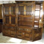 An 'Old Charm' oak four-piece lounge unit, comprising a bookcase, the upper part with four leaded-