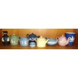 A collection of six Wedgwood small jasperware teapots: one yellow, one green, one pink, two light