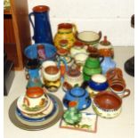 A collection of Torquay Pottery mottoware, including vases, bowls, teapots, jugs, etc.