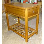 A modern stained wood table fitted with end drawers, on square legs united by a pierced undertier,
