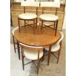 A G-Plan Fresco circular extending dining table, 122cm diameter, closed, and a set of six