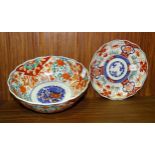 A Japanese Imari decorated bowl of typical design, 23.5cm diameter, 10cm high and a similar plate,