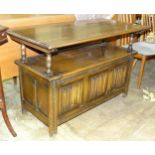 A mid-20th century oak monk bench with hinged seat and linen-fold panel, 117cm wide.