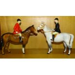 A Beswick Huntsman on brown gloss horse and a Beswick Huntswoman on grey gloss horse, both 21.5cm