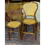 Two early 20th century cane-seat deportment chairs.