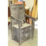 An antique carved oak chair, with lift box seat, (worm damage to one side).