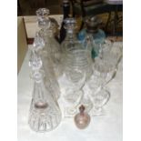 A pair of conical cut glass decanters and stoppers, 31cm high, a purple glass decanter, 31cm high,