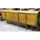 A G-Plan Fresco dining suite, comprising: a sideboard fitted with four central drawers flanked by