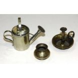 A plated miniature watering can, 7cm high, a miniature brass matchstrike in the form of a