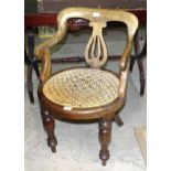 A 19th century mahogany armchair with circular caned seat, on turned front legs, (caning stretched