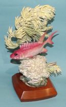 A Royal Worcester model group of a "Squirrel Fish" by Ronald van Ruyckevelt, no.118/500, on fitted