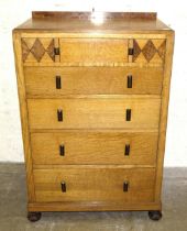 A 1930's inlaid oak chest of five graduated drawers with Bakelite handles, on octagonal bun feet, 76