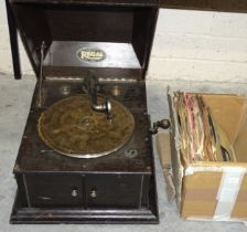 A Regal stained wood-cased gramophone player and a small collection of 78RPM records.