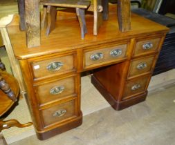 A 19th century walnut kneehole desk fitted with seven drawers, 112cm wide, 77cm high, (converted