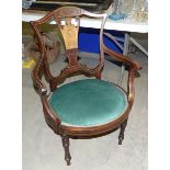 An Edwardian inlaid salon chair with oval seat, on turned legs.
