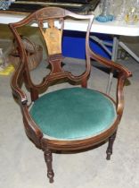 An Edwardian inlaid salon chair with oval seat, on turned legs.