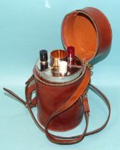 A mid-20th century travelling spirit decanter set, containing three shaped flasks and four gilt-