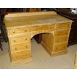 A Victorian pine kneehole desk/dressing chest, having an arrangement of nine small drawers, 123cm