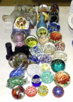 A collection of modern paperweights, a ship in a bottle and other items.
