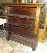 A 20th century oak freestanding bookcase with dentil cornice, 125cm wide x 134cm high.