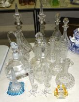 A collection of 19th century and later glass decanters, a pair of small vases with starfish bases,