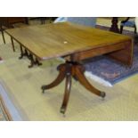 A 19th century mahogany drop leaf rectangular top breakfast table on turned column and four