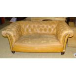 An Edwardian two-seater Chesterfield settee, (worn Rexine upholstery), 158cm wide and a low deep-