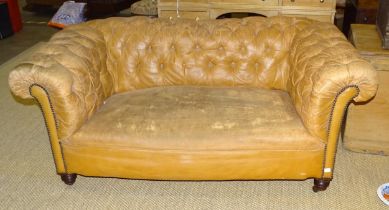 An Edwardian two-seater Chesterfield settee, (worn Rexine upholstery), 158cm wide and a low deep-