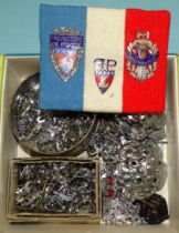 A collection of various police constabulary badges, collar dogs, numbers, cloth badges and
