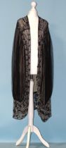 A 1920's black and silver-beaded three-quarter-length evening jacket of black net lined with cream