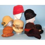 A 1920's straw cloche hat by Couret-Mallet, a felt cloche hat and six later similarly-designed hats,