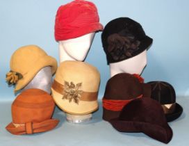 A 1920's straw cloche hat by Couret-Mallet, a felt cloche hat and six later similarly-designed hats,