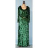 A 1930's emerald green devoré velvet evening dress with long sleeves, the fitted bodice fastened