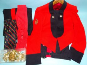 A 1960's Royal Marines red/black mess dress jacket with cloth insignia for rank of staff sergeant,